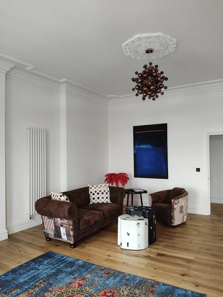 Belle Etage suite sitting area with velvet sofa and feature lighting at Lavish Collections Great Yarmouth