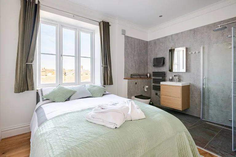 Seraphine suite king bedroom with ensuite shower room and calming tones at Lavish Collections Great Yarmouth